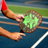 Onix Graphite Evoke XL Pickleball Paddle, Person holding the paddle on a pickleball court in a ready stance