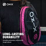 Person carrying a black and pink Onix backpack with text about durability.