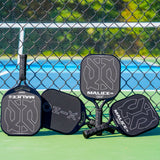 ONIX Malice DB Open Throat Raw Carbon Fiber Pickleball Paddle, lifestyle photo, four paddles resting against a fence