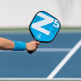 Z5 Mod Series Graphite Pickleball Paddle in guys hand lifestyle mod-blue