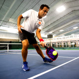 Onix Graphite Evoke XL Pickleball Paddle, person holding the paddle, swinging to hit the ball