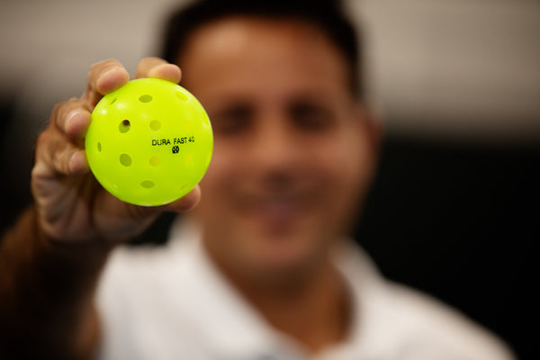 ONIX pro pickleball player Altaf Merchant holding DURA Fast-40 pickleball ball