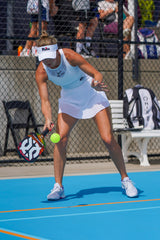ONIX Supercell 22mm Pickleball Paddle, lifestyle photo, woman returning a serve
