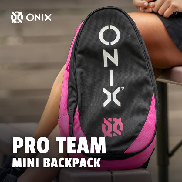 Pink and black backpack with 'ONIX' branding on a blurred background