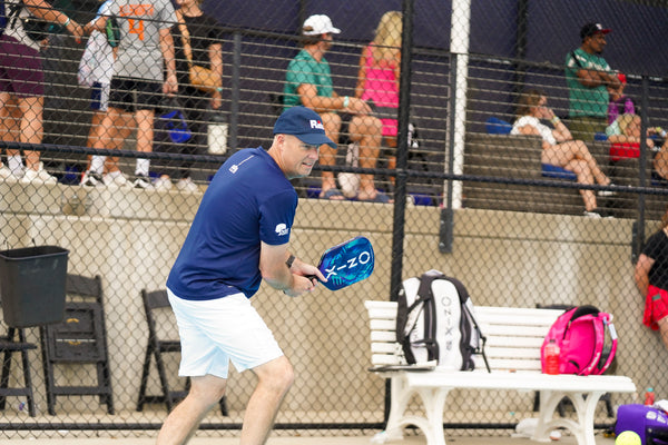 ONIX Supercell 22mm Pickleball Paddle, lifestyle photo, person getting ready for a backhand